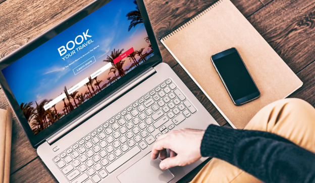 Male using a laptop to book a cheap vegas trip.