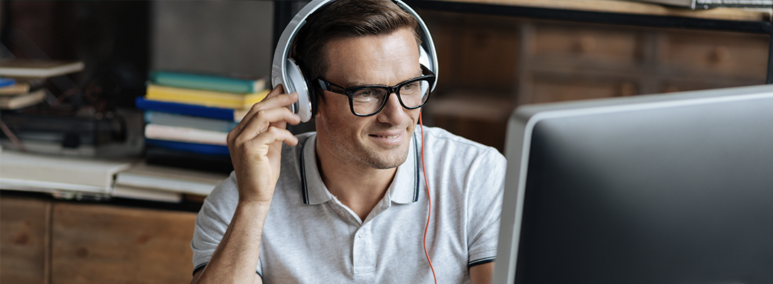 Man Listening to Sports Betting Podcasts at Home