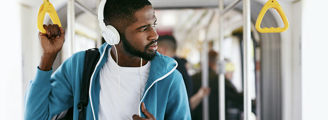 Man Listening to Sports Betting Podcasts on Bus